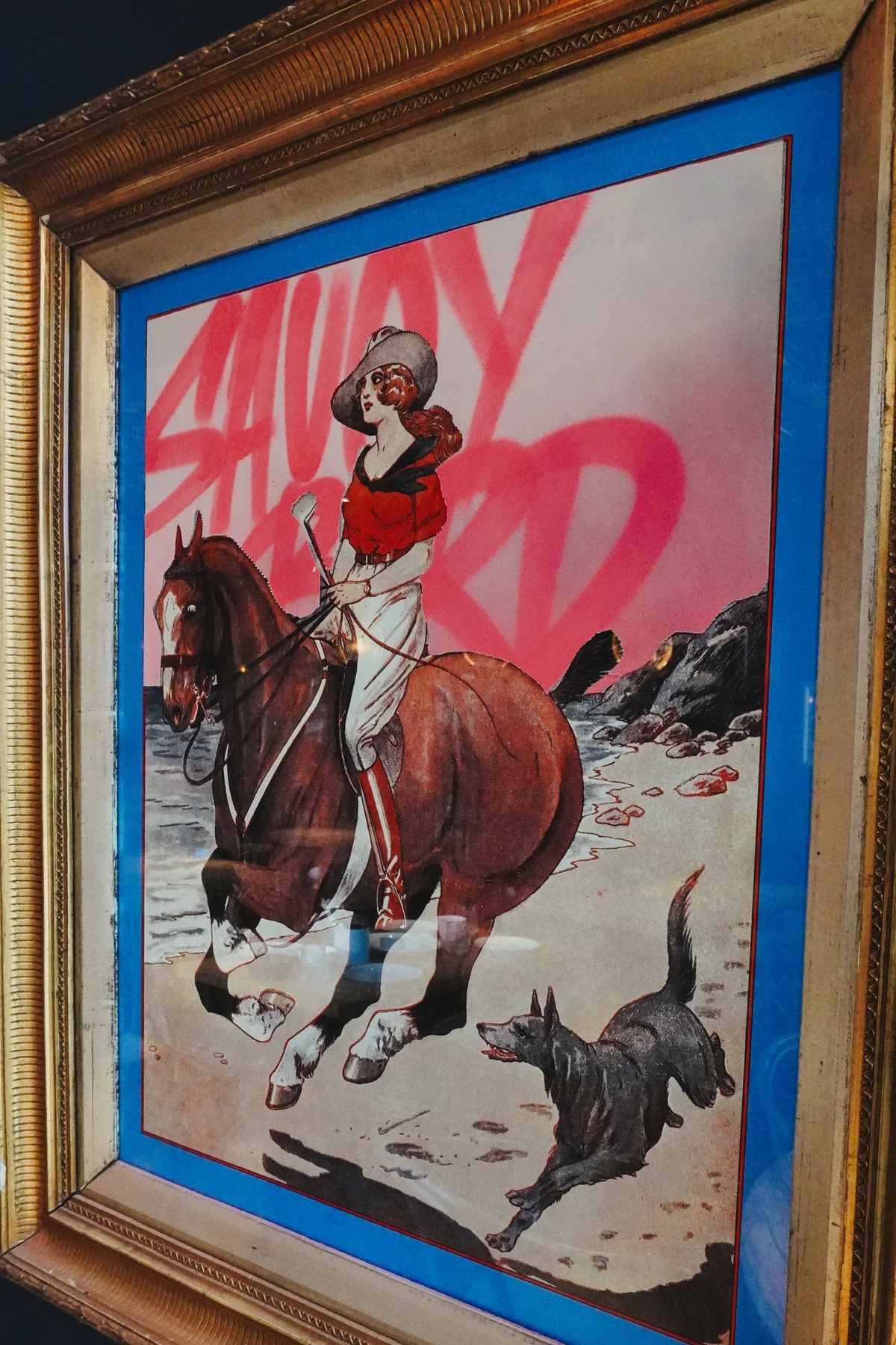 Framed Saucy Bird character artwork on the restaurant wall
