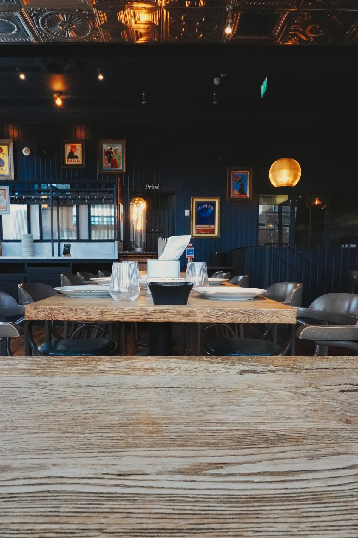 Set wooden table facing the bar
