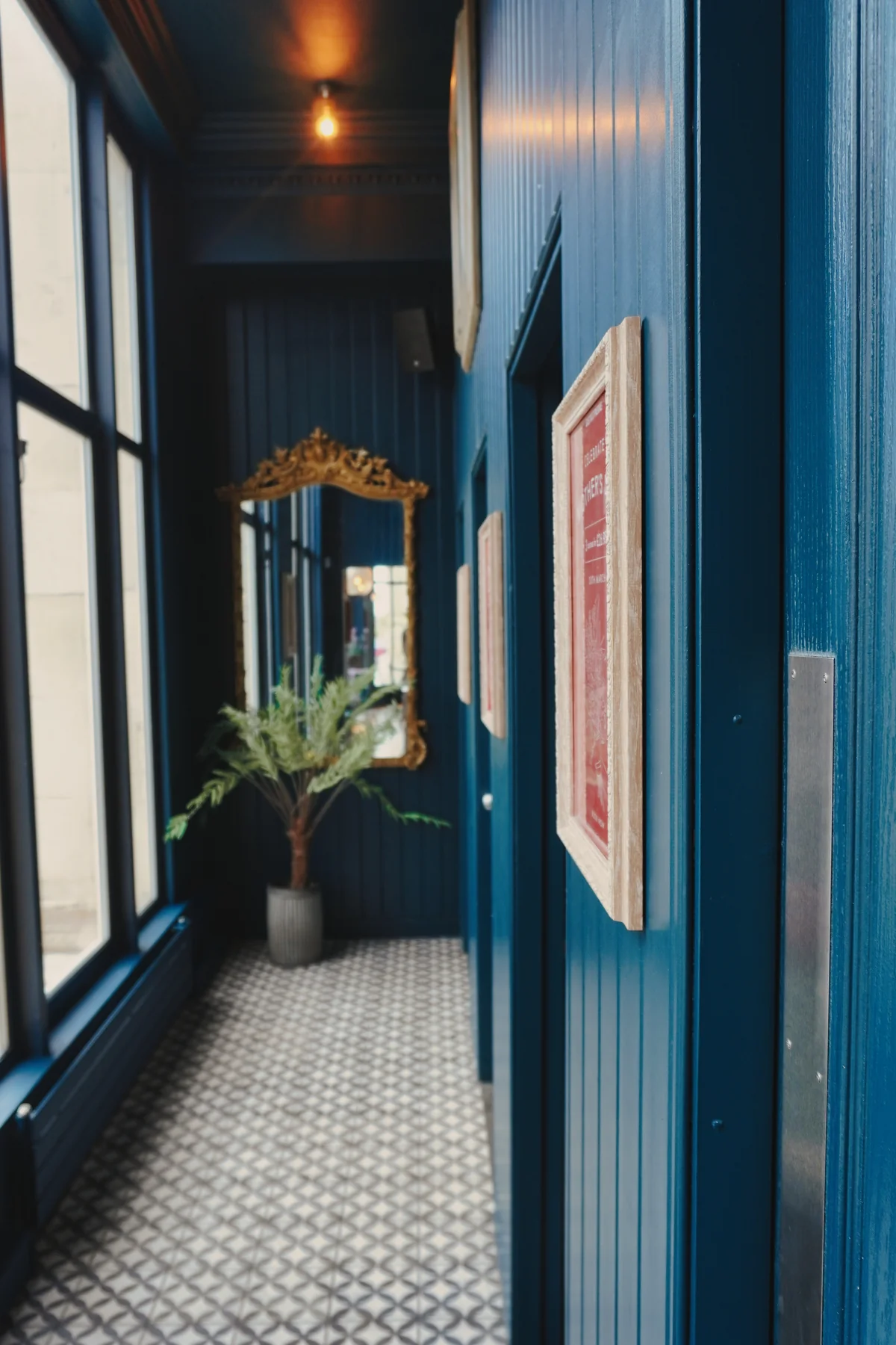 Restaurant corridor with dark panelling and window light