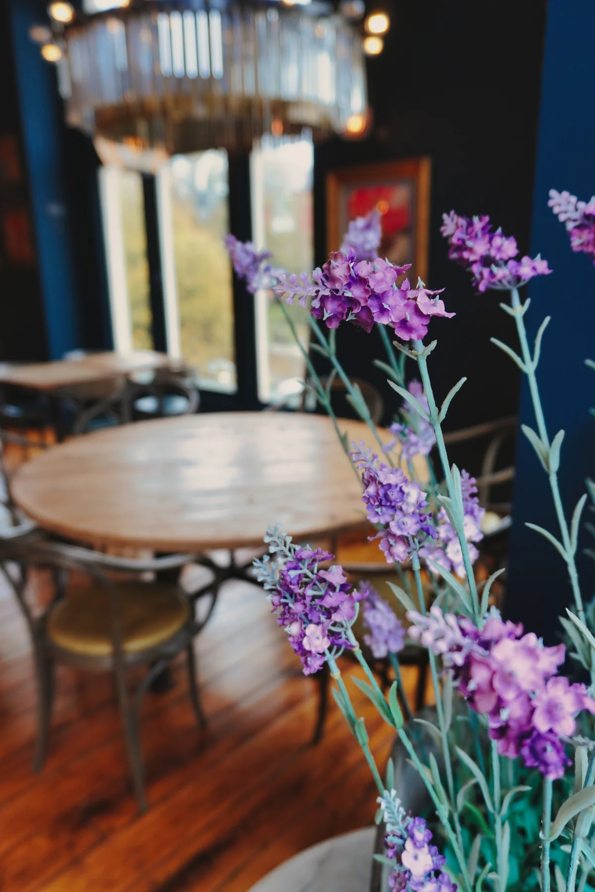 Flowers beside the dining tables and chandelier