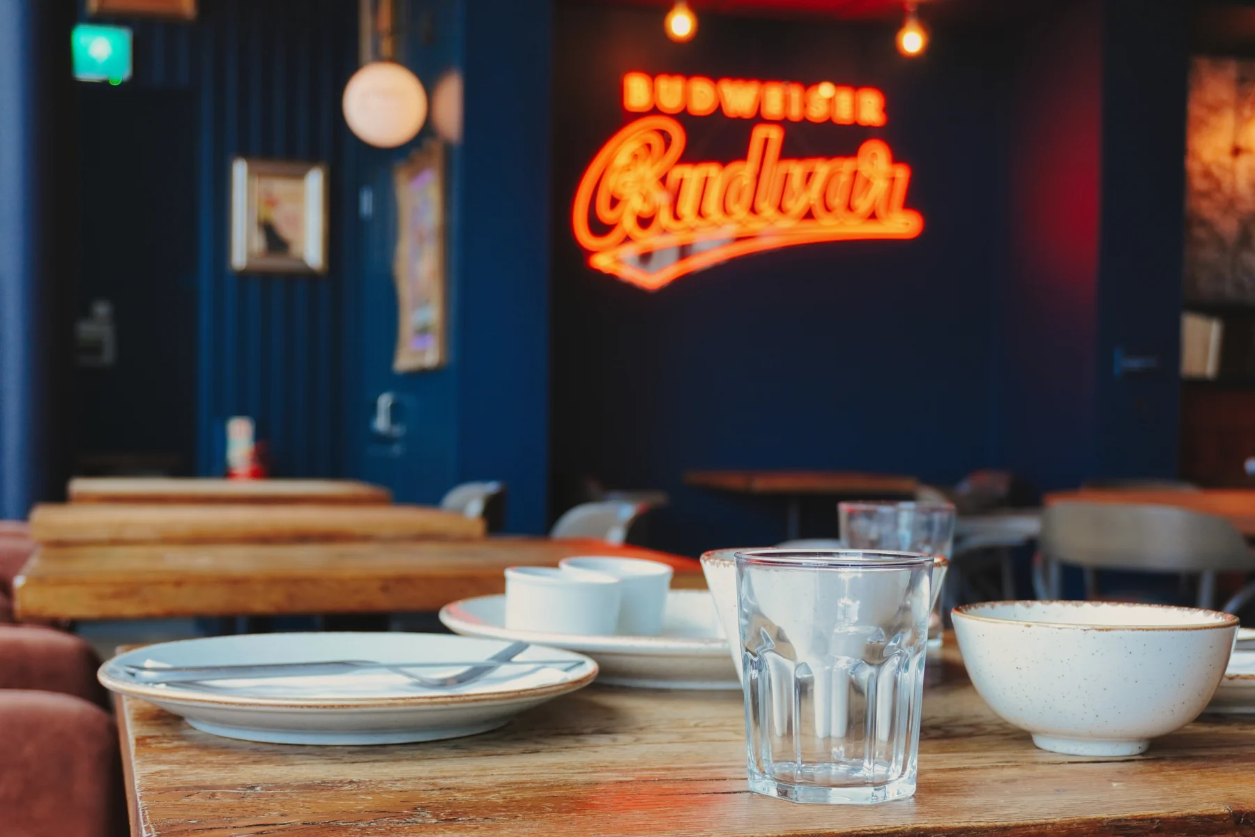Table setting with the glowing Bowland Brewery sign behind